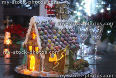 Stock image of gingerbread house on Christmas dinner table at night