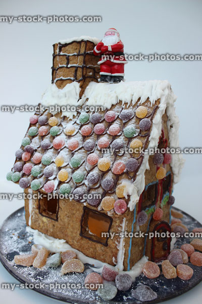 Stock image of homemade Christmas gingerbread house with sweets, Santa Claus
