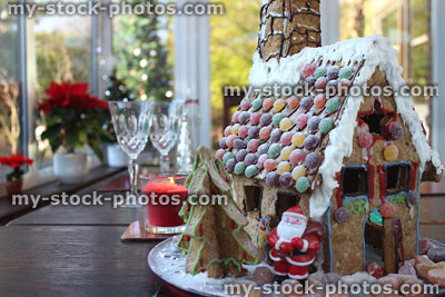 Stock image of Santa Claus toy with iced Christmas gingerbread house