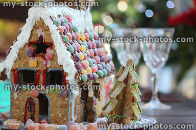 Stock image of biscuit gingerbread house with sweets and wine glasses