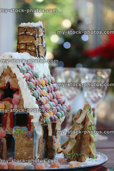 Stock image of biscuit gingerbread house with sweets as roof tile decorations