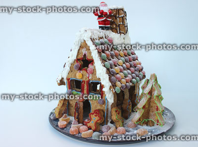 Stock image of homemade Christmas gingerbread house decorated with sweets / biscuits