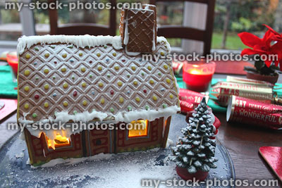 Stock image of gingerbread house with Christmas tree and icing sugar