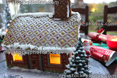 Stock image of gingerbread house with candles and Christmas crackers / tree