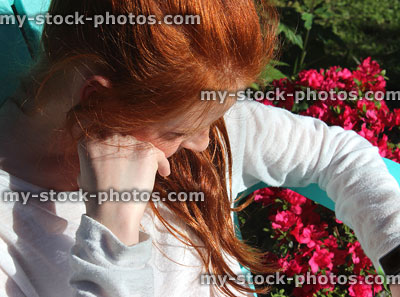 Stock image of girl using smart watch outside in garden, checking apps