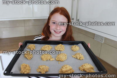 Stock image of girl baking in kitchen, making biscuits / cookies