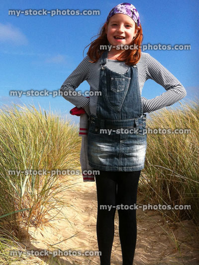 Stock image of red haired girl among sand dunes