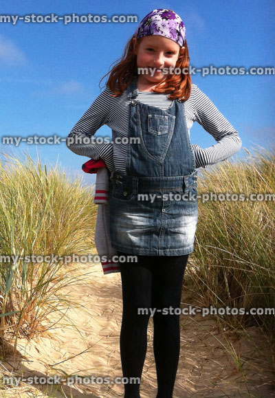 Stock image of red haired girl among sand dunes