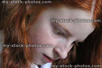 Stock image of young girl thinking and daydreaming / concentrating face / long hair