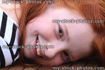 Stock image of girl sunbathing in garden, lying on wooden sunlounger