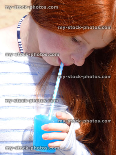 Stock image of girl drinking unhealthy slushie drink from plastic cup