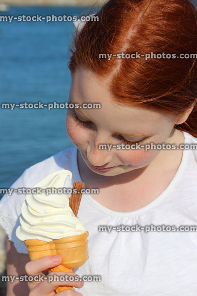 Stock image of girl on seaside holiday, eating ice cream cone (99 whippy)