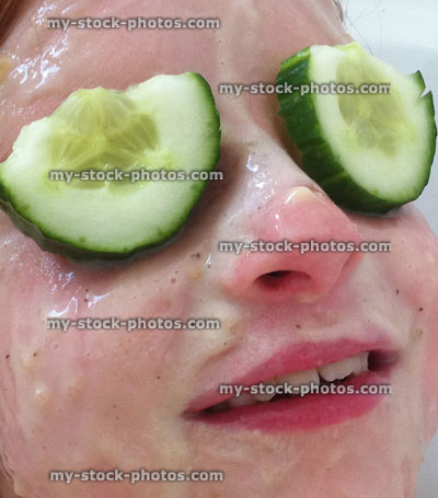 Stock image of child with homemade facepack / facial in bath, cucumbers