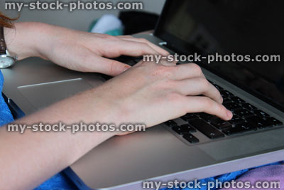 Stock image of girl using laptop computer for school homework, studying in bedroom