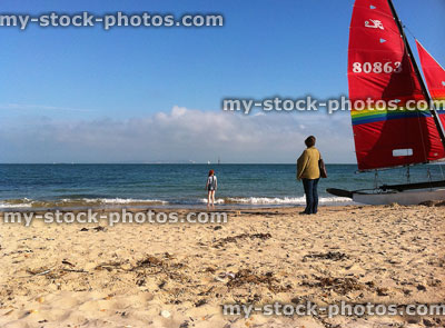 Stock image of small boat on sandy beach, next to sea