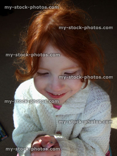 Stock image of young girl sat down, thinking thoughts to herself