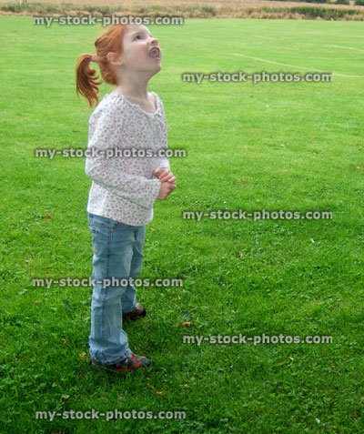 Stock image of little girl on a playing field having fun