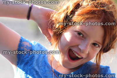 Stock image of dressed up girl with messy red hair posing, French braid