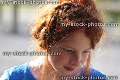 Stock image of dressed up girl with messy red hair posing, French braid
