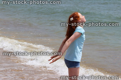 Stock image of pretty young girl enjoying the sun at beach / seaside