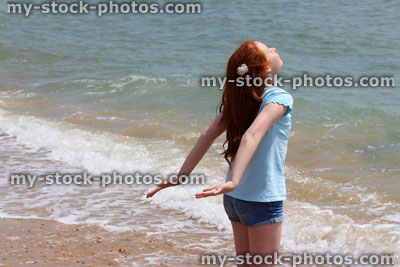Stock image of pretty young girl enjoying the sun at beach / seaside