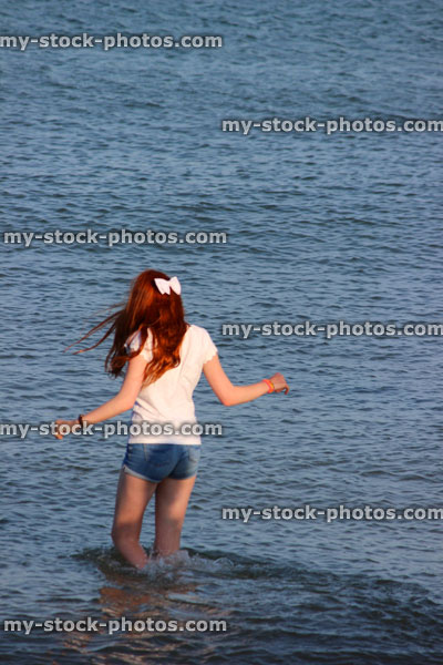 Stock image of girl paddling in sea waves, legs, water, wading, seaside beach