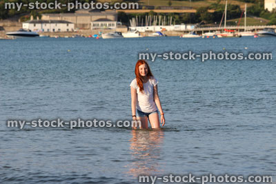 Stock image of girl paddling in sea waves, legs, water, wading, seaside beach