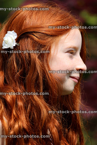 Stock image of pretty, happy girl with long red hair