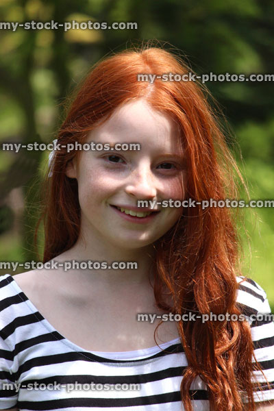 Stock image of beautiful, happy girl with long red hair