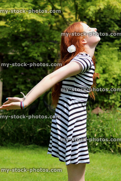Stock image of attractive young girl enjoying the sun in garden