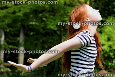 Stock image of beautiful young girl enjoying the sunshine in garden