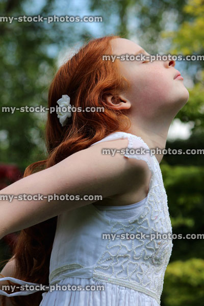 Stock image of beautiful young girl enjoying the sun in garden, white dress