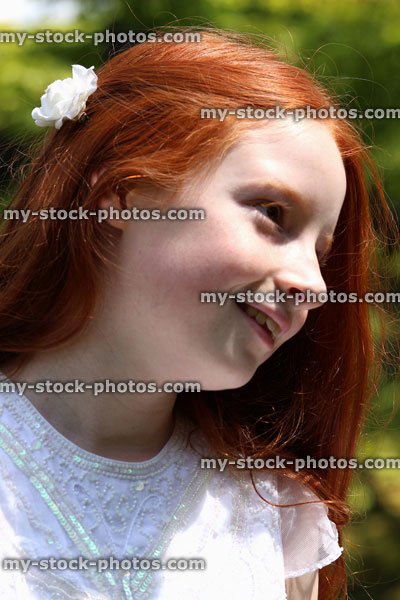 Stock image of attractive, happy girl with long red hair