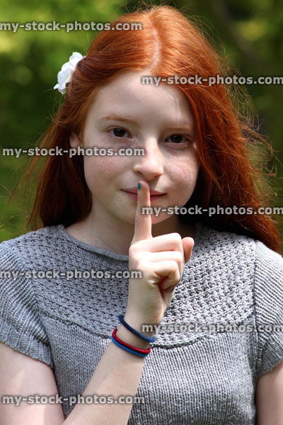 Stock image of girl with finger on her lips shhhhh