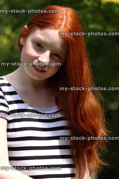 Stock image of girl with brushed long red hair in sunshine
