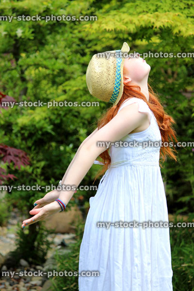 Stock image of pretty young girl enjoying the sunshine in garden