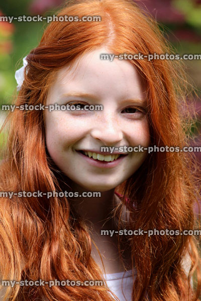 Stock image of happy girl's face and long hair, smiling, laughing (close up)