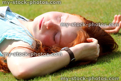 Stock image of girl sleeping / daydreaming / dreaming / sunbathing on garden lawn