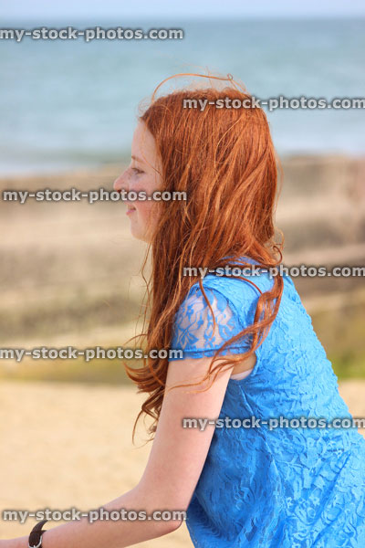 Stock image of girl standing on beach by sea, seaside summer holiday, daydreaming