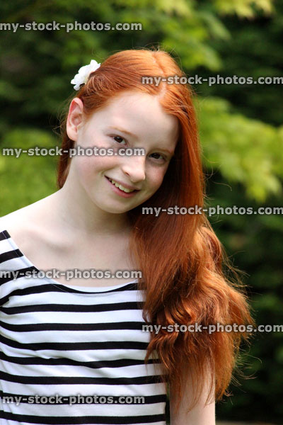Stock image of girl with brushed long red hair in sunshine
