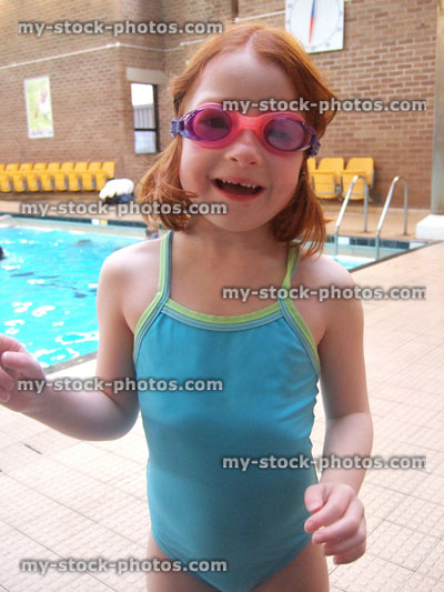 Stock image of little girl on the side of swimming pool
