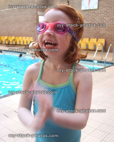 Stock image of little girl next to a swimming pool