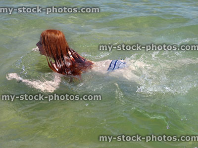 Stock image of girl swimming in the sea doing breast stroke