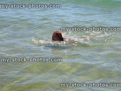 Stock image of girl swimming in clear sea during seaside holiday