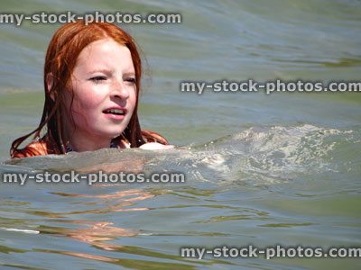 Stock image of girl swimming in sea water at English seaside
