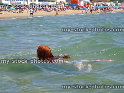 Stock image of girl swimming in sea at Bournemouth beach, England