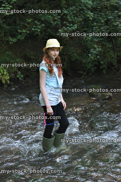 Stock image of girl playing, paddling, wading in river, woodland stream