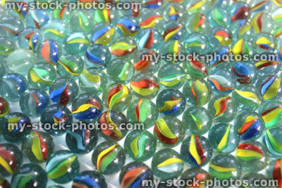 Stock image of coloured glass marbles sparkling in sunshine, toy game
