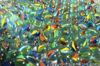 Stock image of coloured glass marbles sparkling in sunshine, toy game