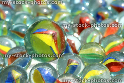 Stock image of large marble with smaller marbles, odd one out